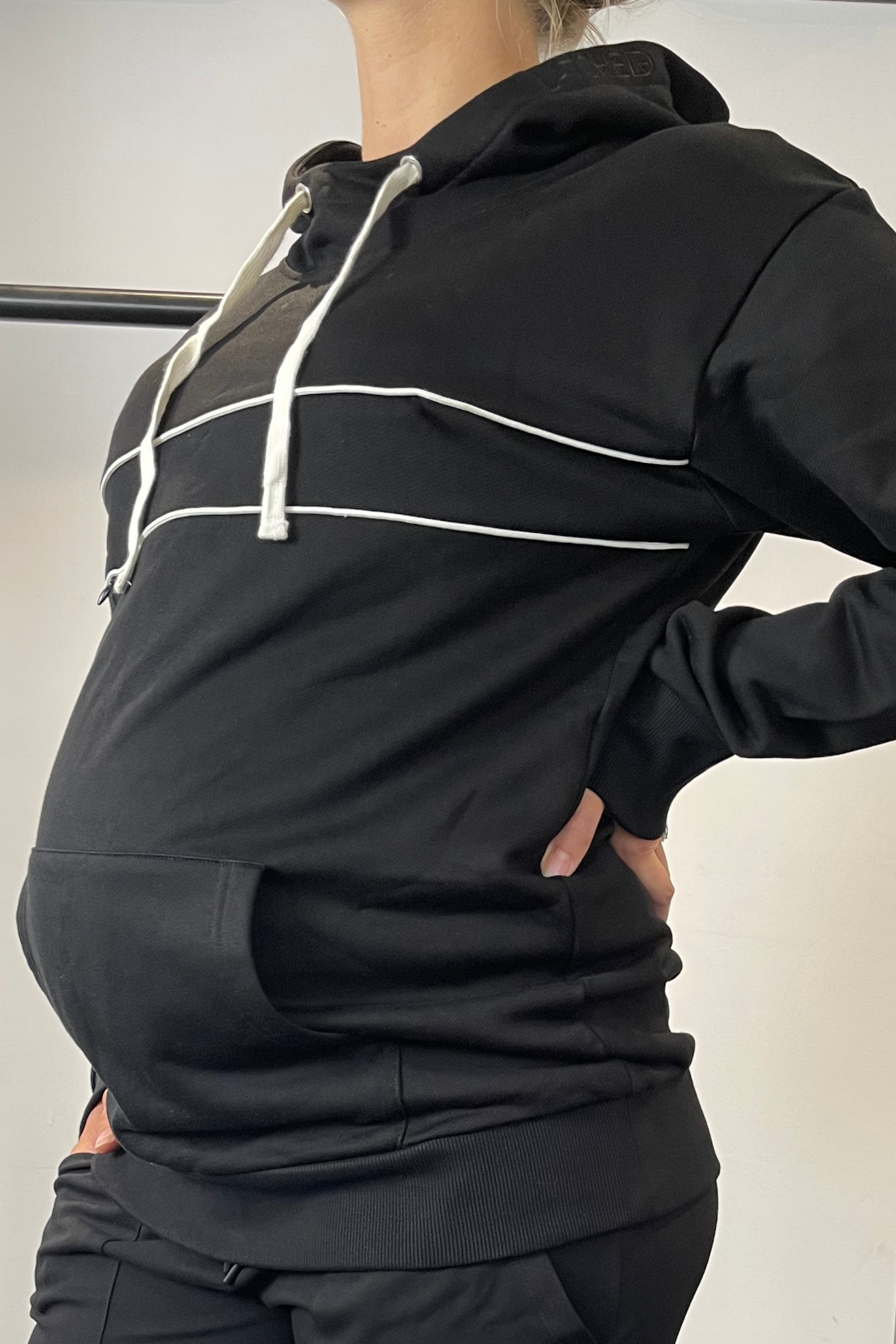 Black maternity and breastfeeding hoodie with side zips over baby bump